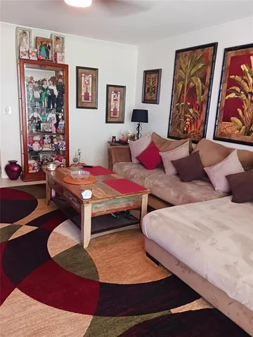 a bedroom with a bed and wall painting on the wall