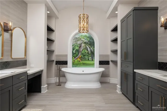 a spacious bathroom with a bathtub a sink and a window