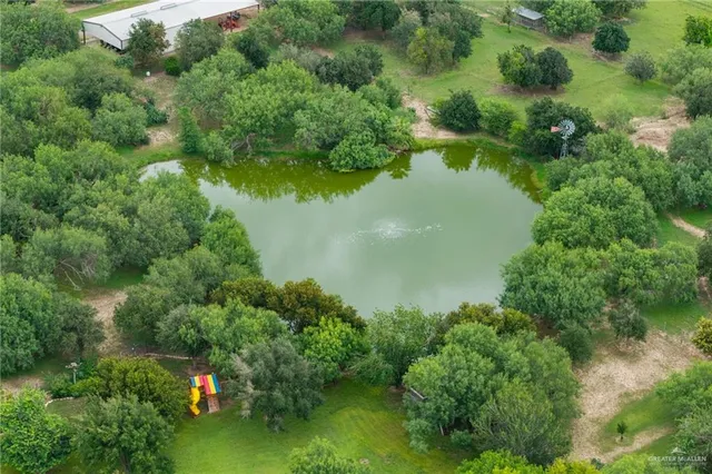 an aerial view of residential houses with outdoor space and swimming pool