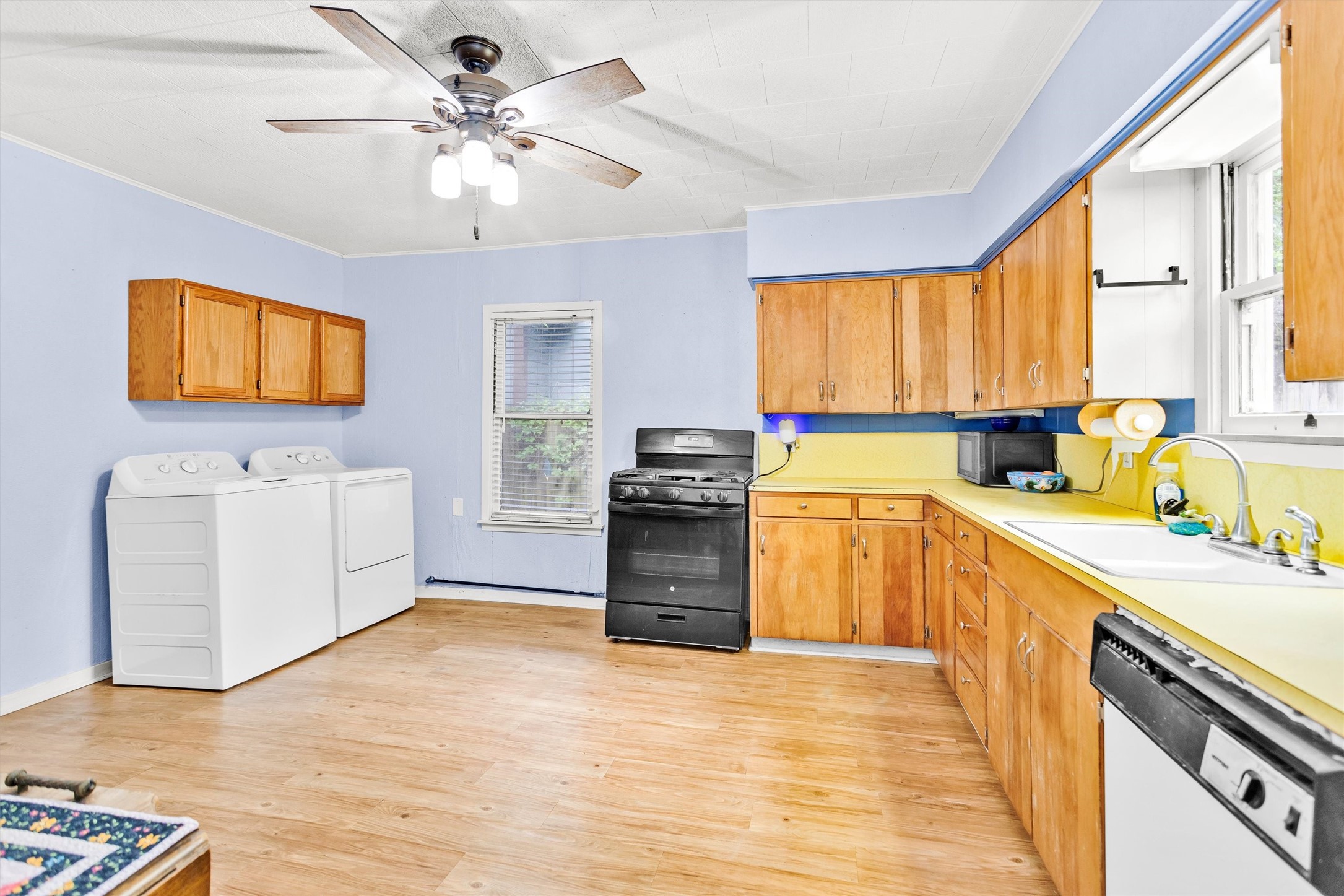 1720 18th Street Huntsville, TX 77340 - Photo 13 of 37 a kitchen with a stove a sink and a refrigerator