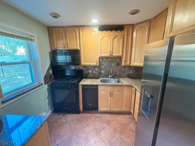 a kitchen with a sink a stove and cabinets