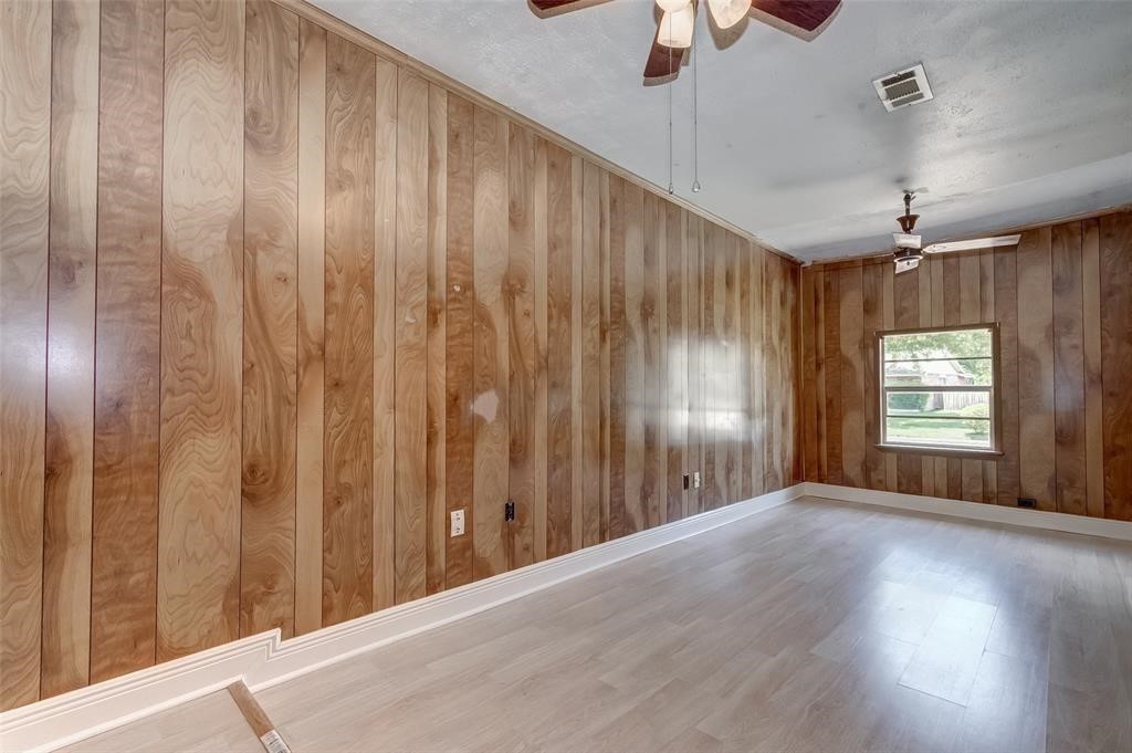 7659 Winkle Wood Lane Houston, TX 77086 - Photo 11 of 24 a view of a livingroom with a chandelier fan and windows