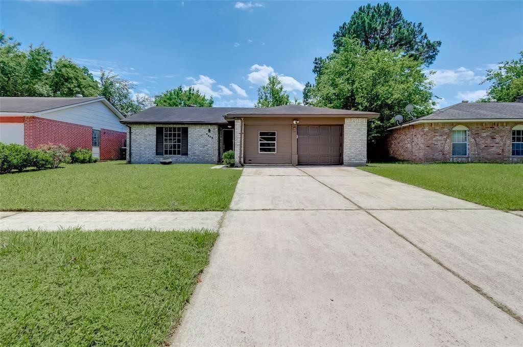 7659 Winkle Wood Lane Houston, TX 77086 - Photo 2 of 24 a front view of house with yard and trees
