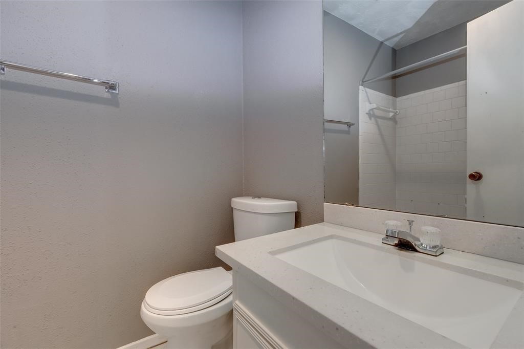 7659 Winkle Wood Lane Houston, TX 77086 - Photo 22 of 24 a bathroom with a sink and a toilet