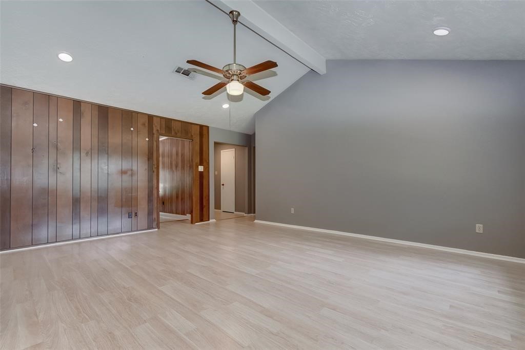 7659 Winkle Wood Lane Houston, TX 77086 - Photo 6 of 24 an empty room with chandelier fan and windows