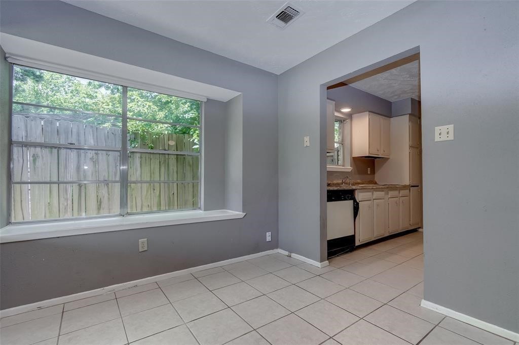 7659 Winkle Wood Lane Houston, TX 77086 - Photo 7 of 24 a view of kitchen with furniture and large window