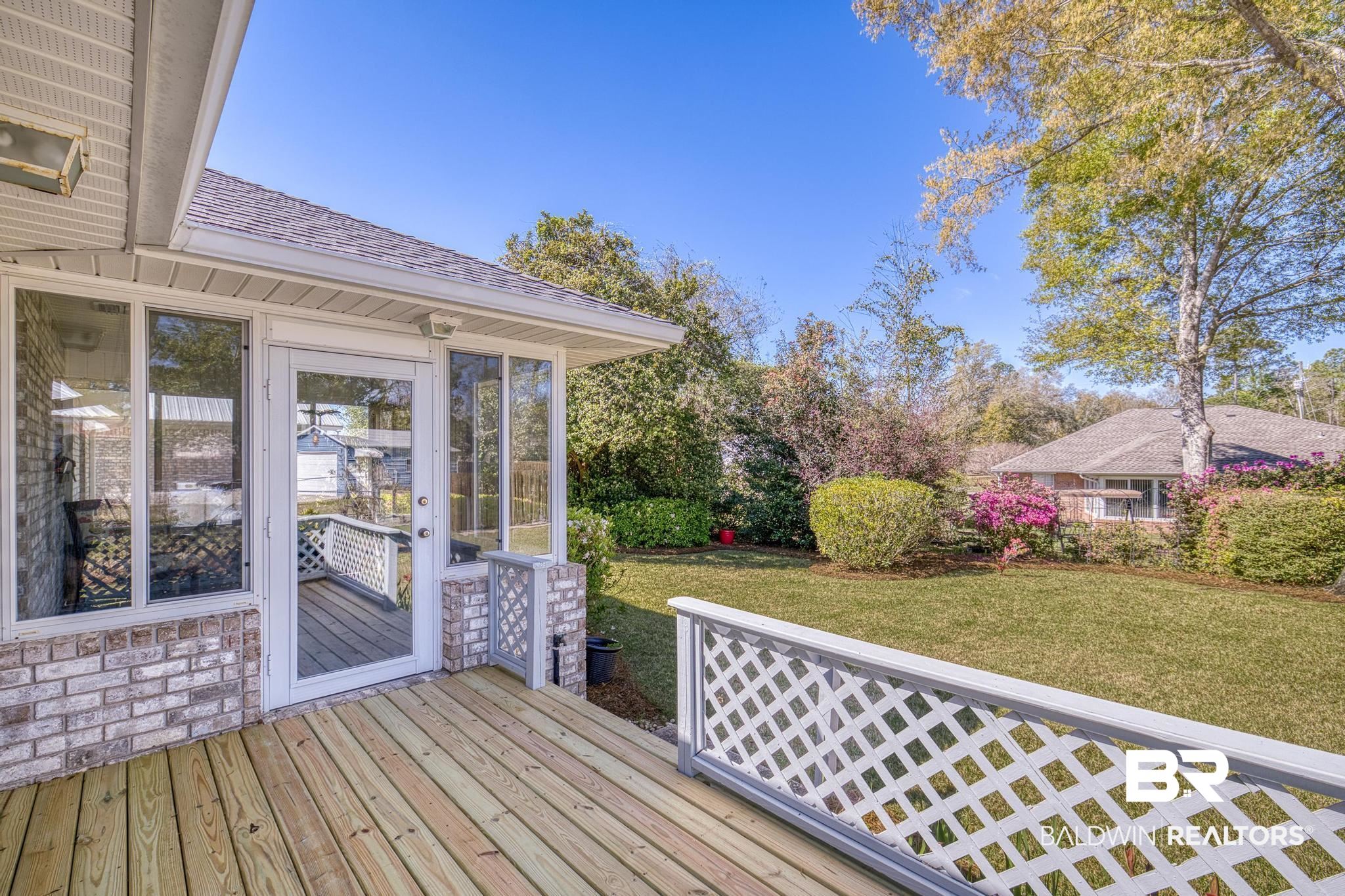 2881 Eslava Circle Lillian, AL 36549 - Photo 25 of 58 Wooden deck featuring a lawn