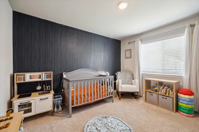a bedroom with furniture and a window