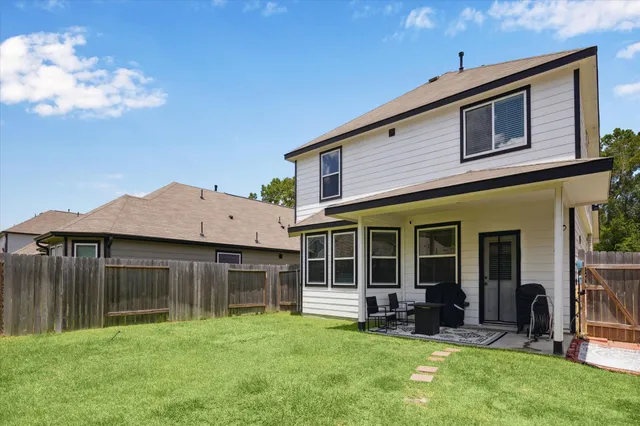 a view of a house with a yard and sitting area