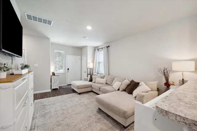 a spacious bedroom with a bed and a flat screen tv