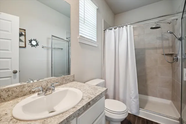 a bathroom with a sink toilet and shower
