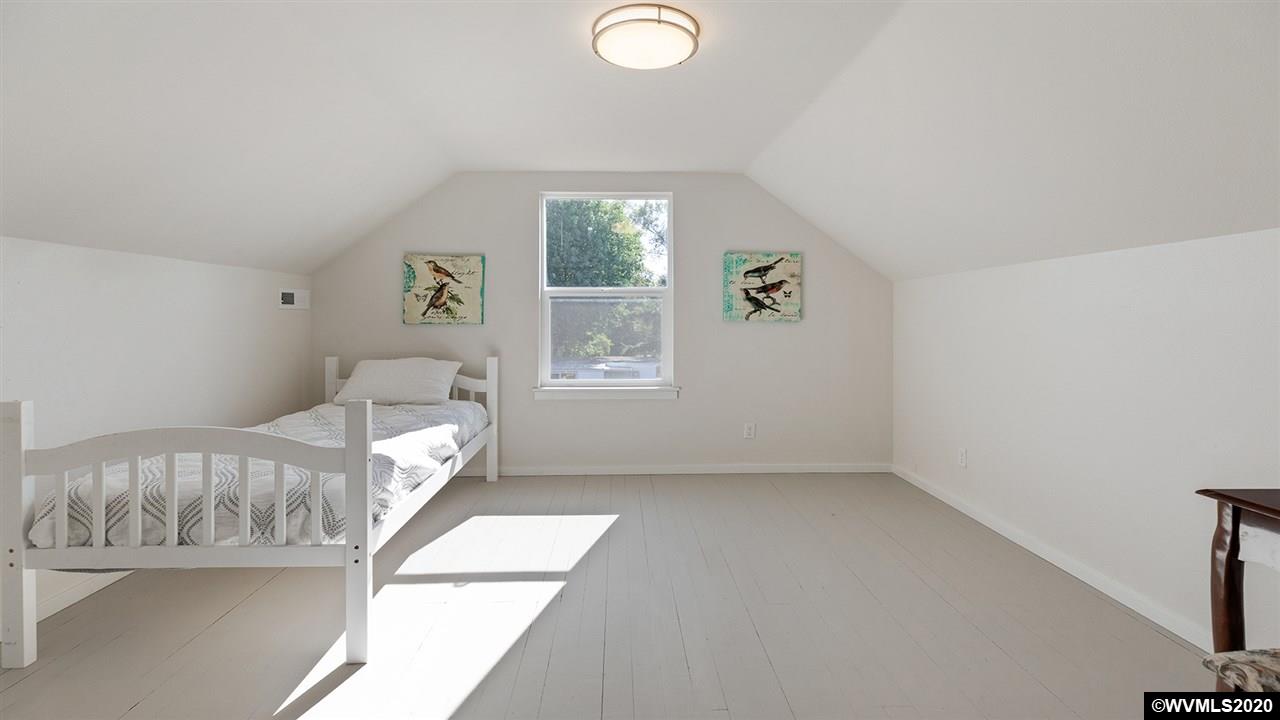 790 Southeast Fir Villa Road Dallas, OR 97338 - Photo 27 of 38 a view of a bedroom with wooden floor and windows