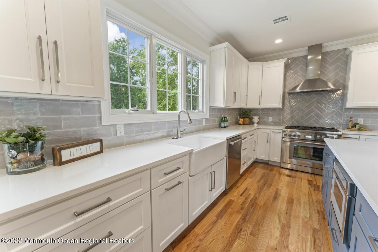 108 Horseneck Point Road Oceanport, NJ 07757 - Photo 13 of 37 a kitchen with sink a microwave and cabinets