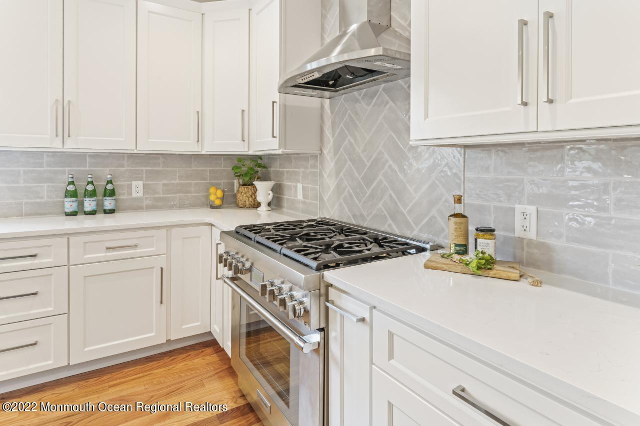 108 Horseneck Point Road Oceanport, NJ 07757 - Photo 14 of 37 a kitchen with white cabinets and appliances
