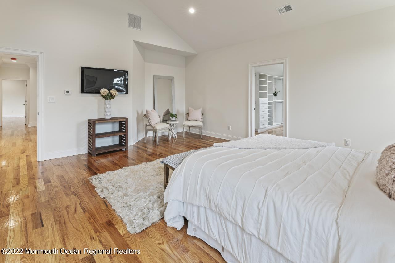 108 Horseneck Point Road Oceanport, NJ 07757 - Photo 23 of 37 a spacious bedroom with a bed and a flat screen tv