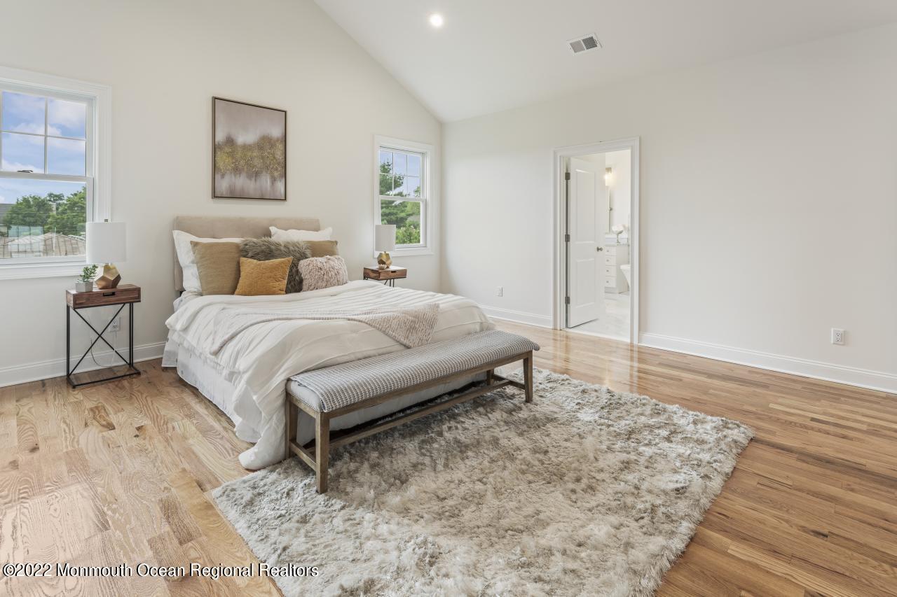 108 Horseneck Point Road Oceanport, NJ 07757 - Photo 24 of 37 a large bedroom with a bed and wooden floor