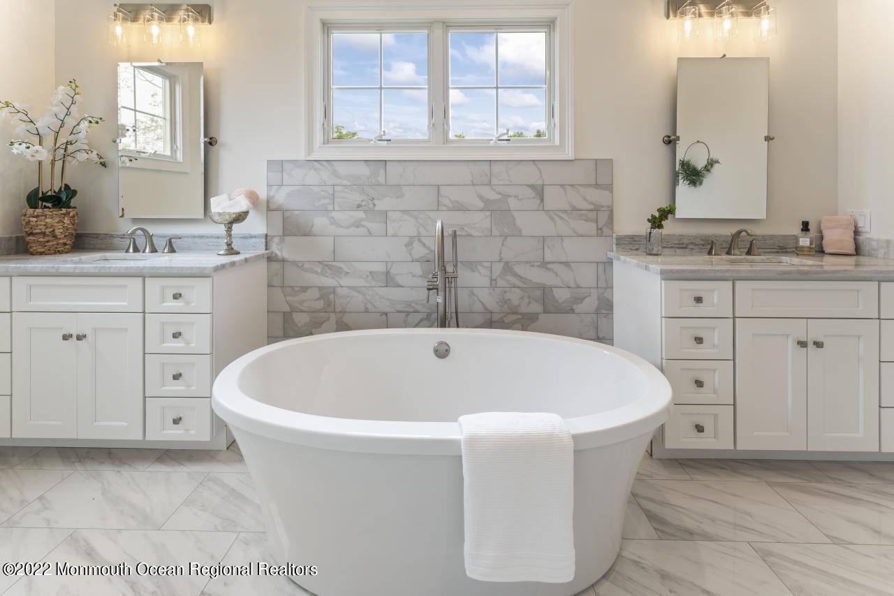 108 Horseneck Point Road Oceanport, NJ 07757 - Photo 25 of 37 a white bath tub sitting in a bathroom and sink
