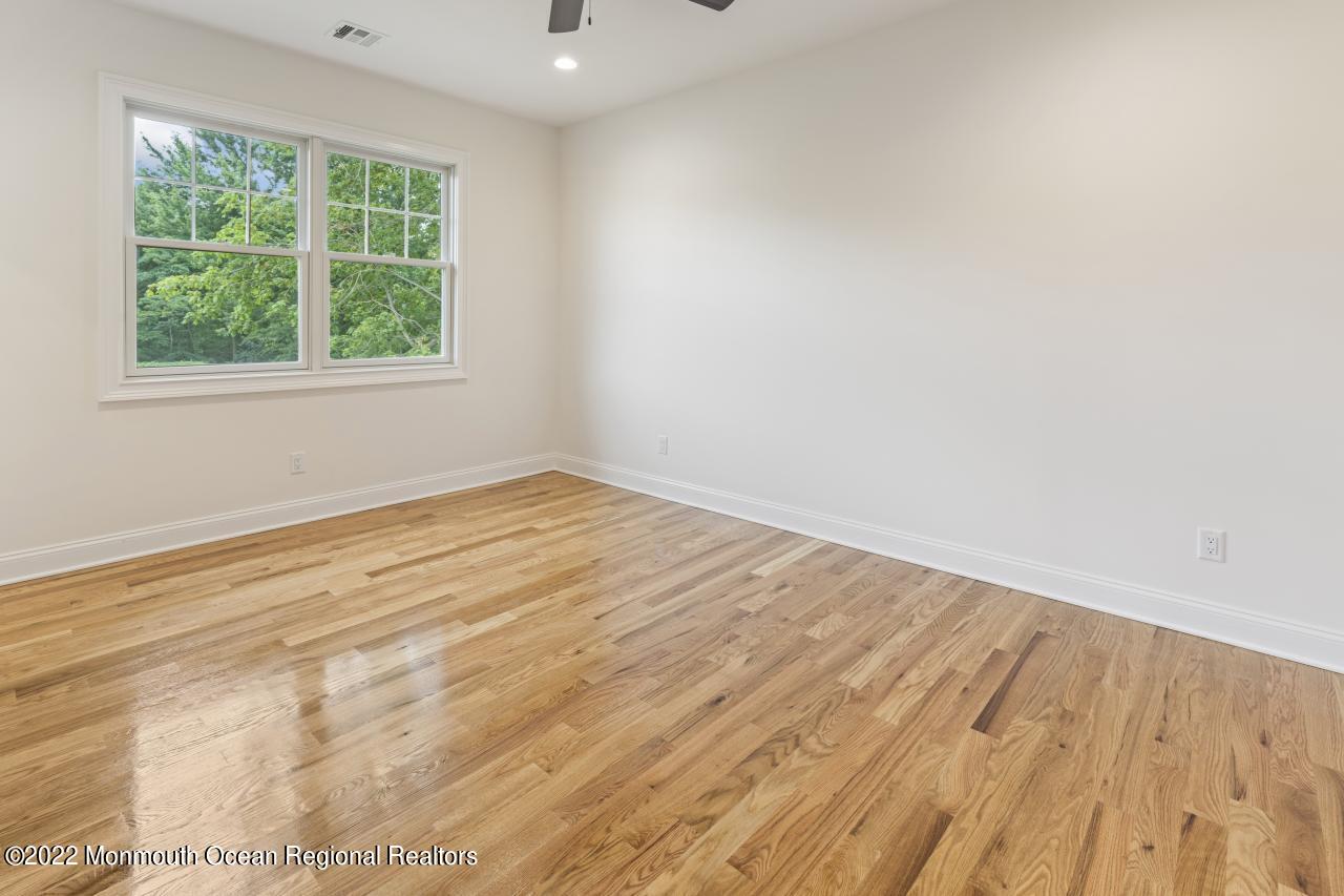 108 Horseneck Point Road Oceanport, NJ 07757 - Photo 30 of 37 an empty room with wooden floor and windows