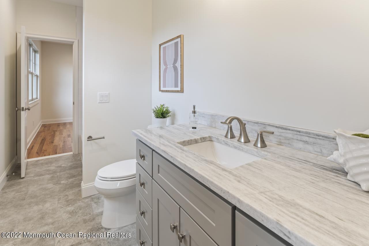 108 Horseneck Point Road Oceanport, NJ 07757 - Photo 31 of 37 a bathroom with a granite countertop sink and a toilet