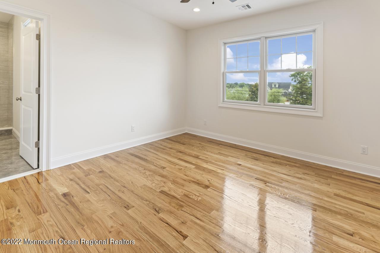 108 Horseneck Point Road Oceanport, NJ 07757 - Photo 33 of 37 wooden floor in an empty room with a window