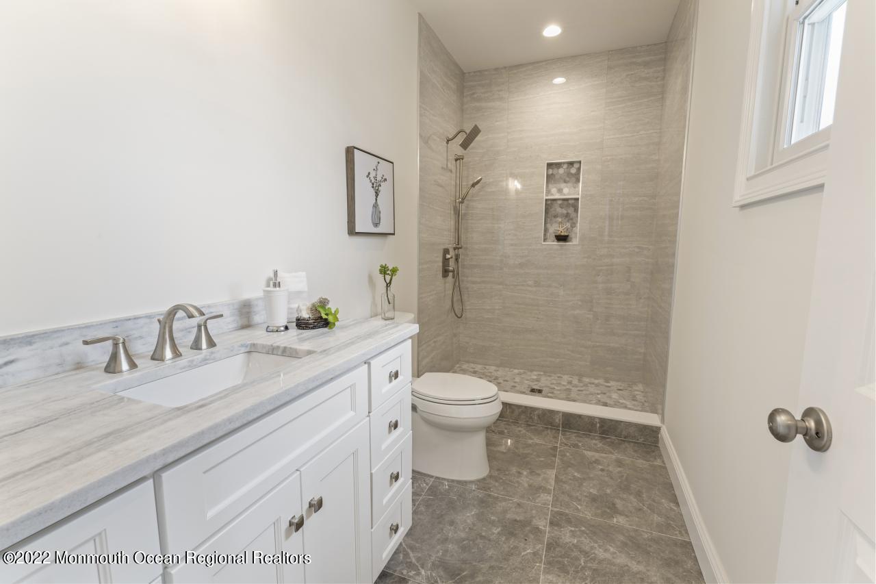 108 Horseneck Point Road Oceanport, NJ 07757 - Photo 34 of 37 a bathroom with a granite countertop sink a toilet and shower