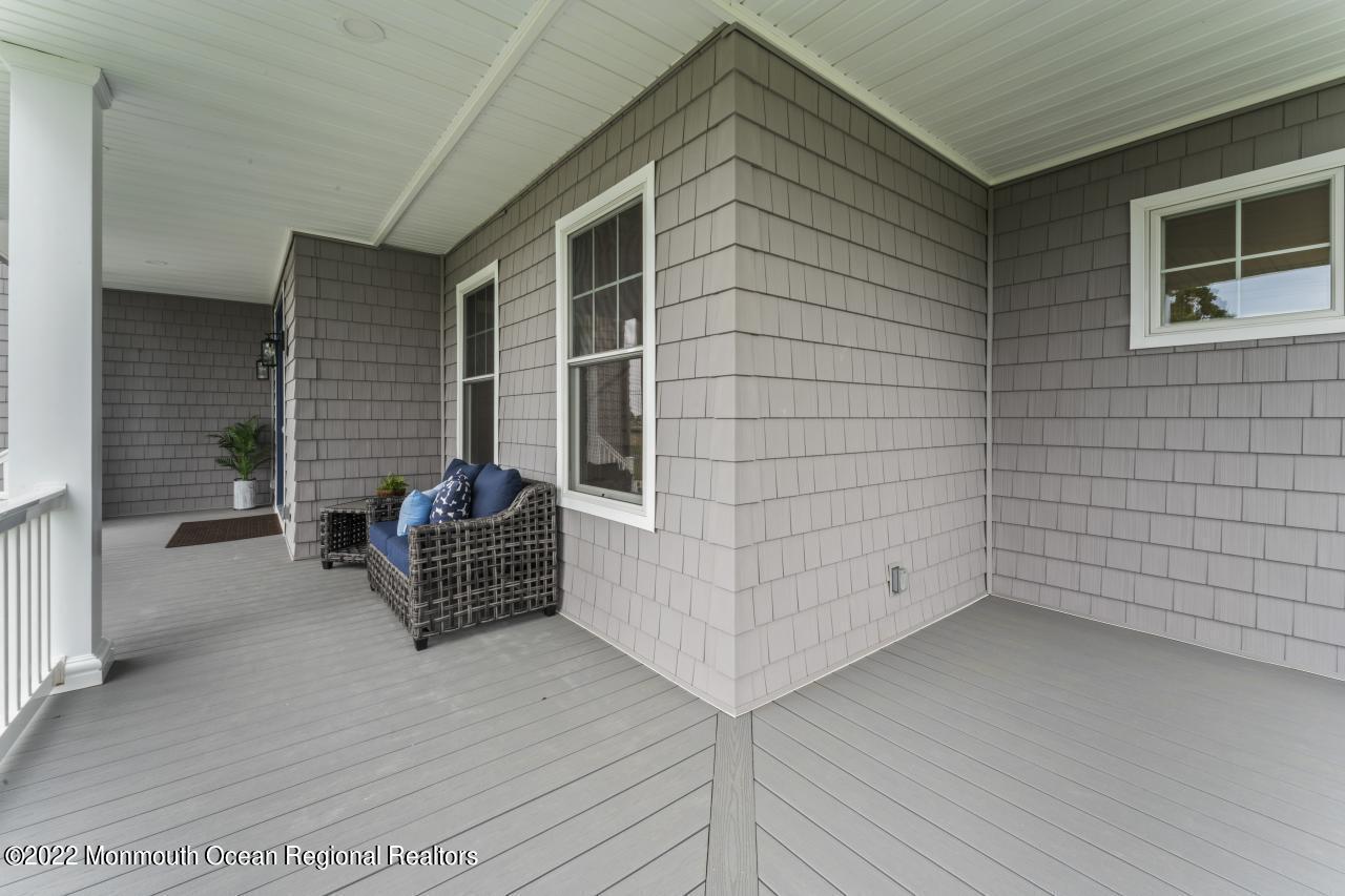 108 Horseneck Point Road Oceanport, NJ 07757 - Photo 7 of 37 a view of wooden door and bench in patio