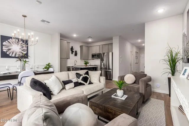 a living room with furniture and a chandelier