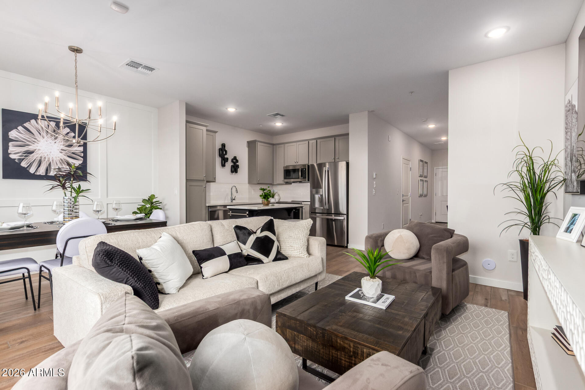 a living room with furniture and a chandelier