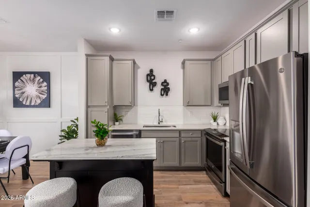 a bedroom with a bed and painting on the wall