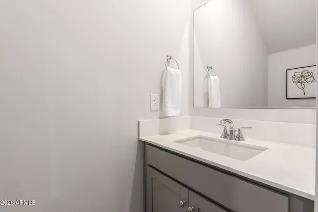 a bathroom with a sink toilet a mirror and shower