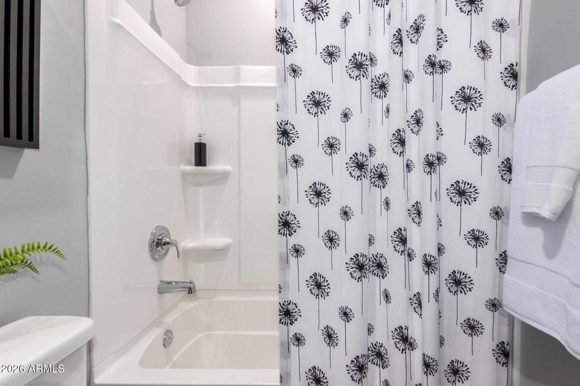 7576 West Darrow Street Laveen, AZ 85339 - Photo 24 of 44 a white bath tub sitting next to a white sink and vanity
