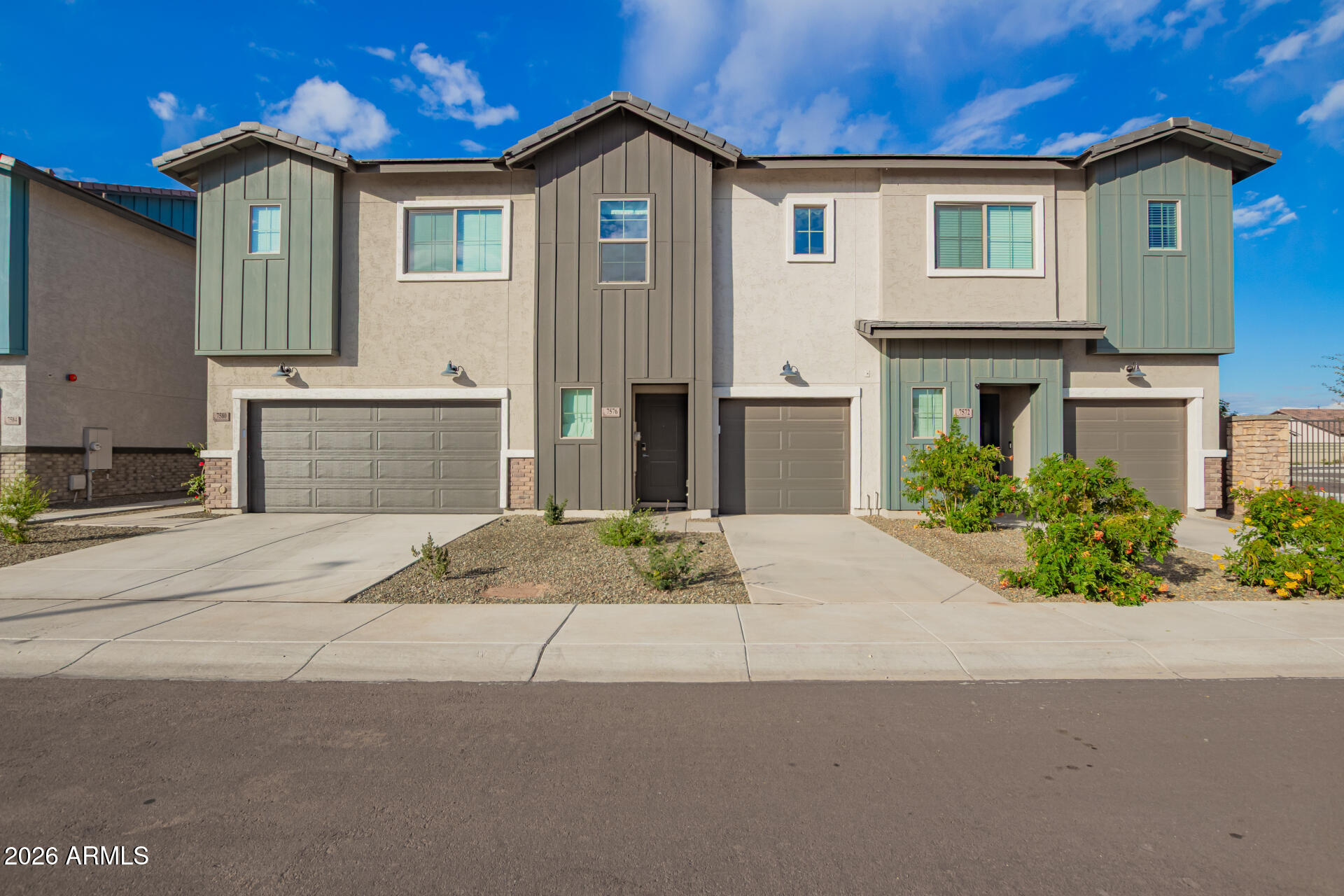 7576 West Darrow Street Laveen, AZ 85339 - Photo 4 of 44 a front view of a house with a yard and garage