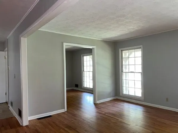 a view of a hallway with wooden floor