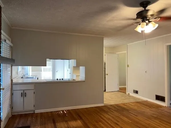 a kitchen with granite countertop white cabinets white stainless steel appliances with a sink and dishwasher