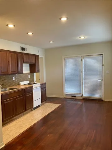 a large kitchen with stainless steel appliances granite countertop a large stove a sink and a microwave