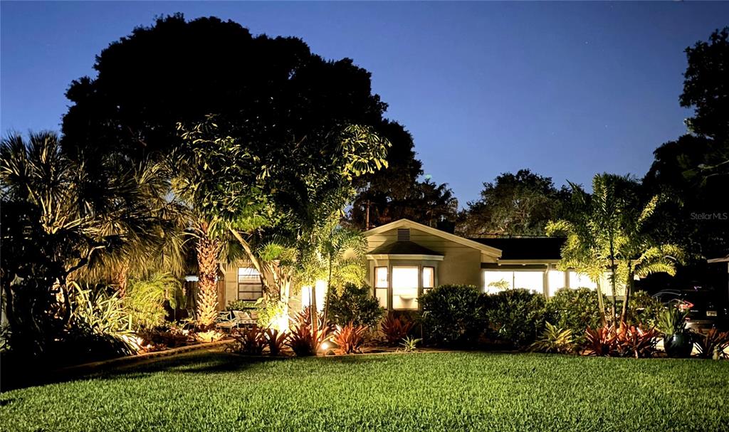 a view of a house with a yard and garden