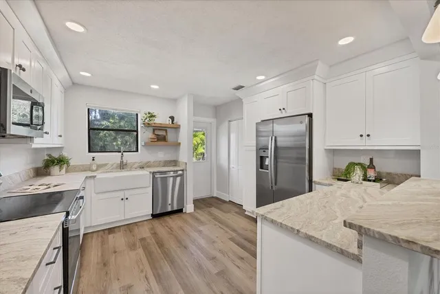 a kitchen with a refrigerator a sink dishwasher with a stove and refrigerator