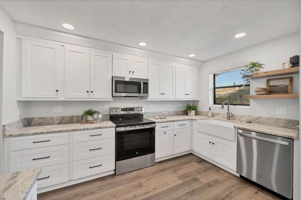4737 Del Rio Way South Gulfport, FL 33711 - Photo 13 of 55 a kitchen with white cabinets appliances and sink