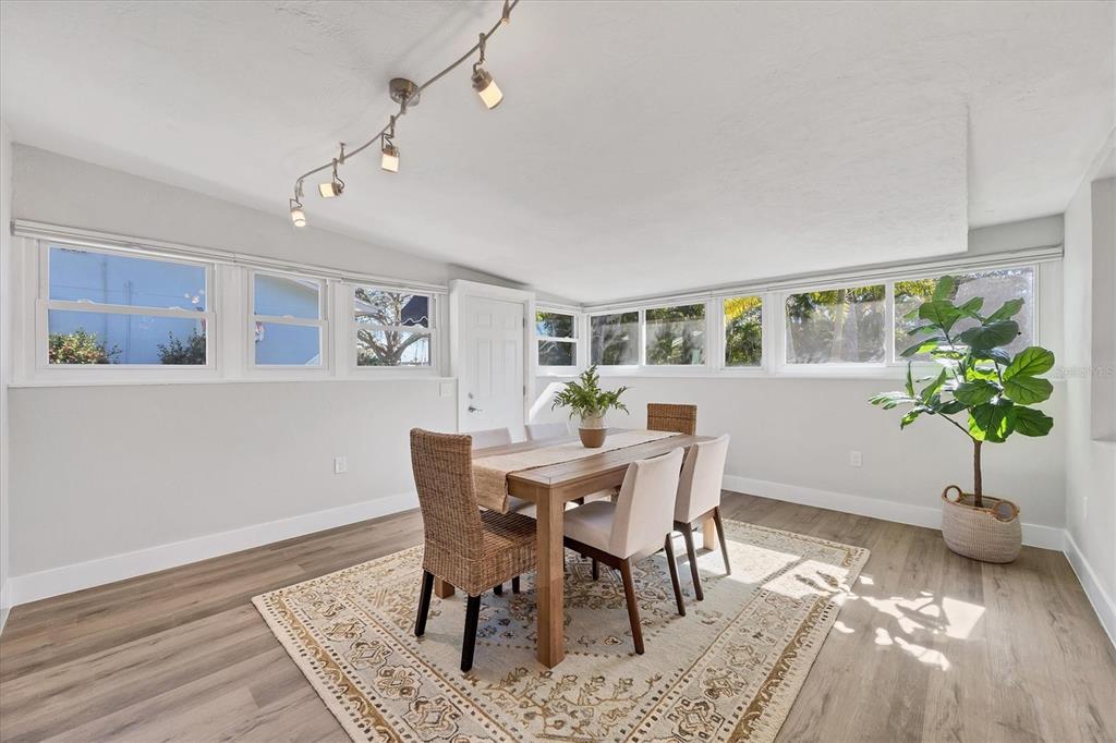 4737 Del Rio Way South Gulfport, FL 33711 - Photo 14 of 55 a view of a dining room with furniture window and wooden floor