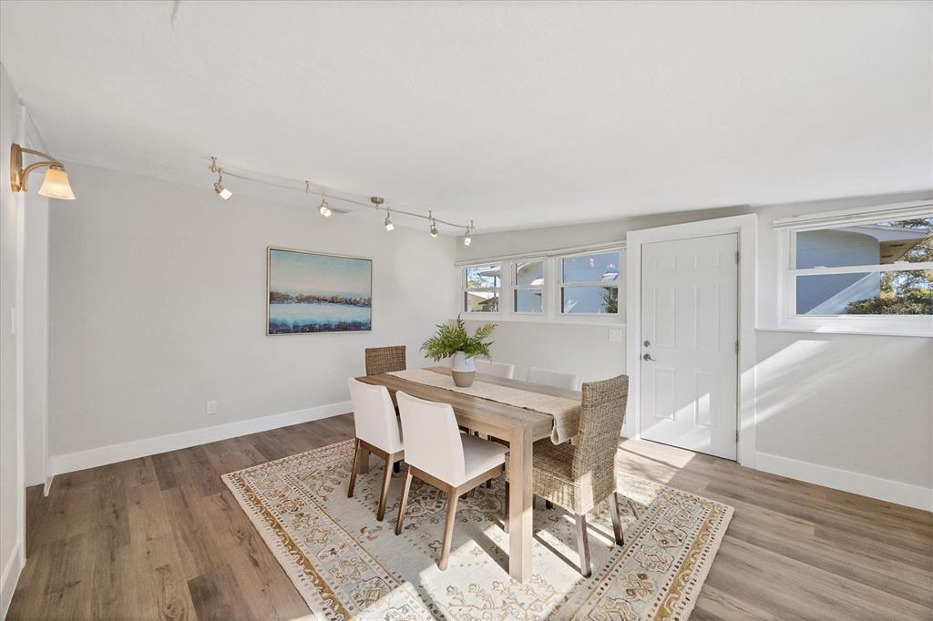 4737 Del Rio Way South Gulfport, FL 33711 - Photo 15 of 55 a view of a dining room with furniture and wooden floor