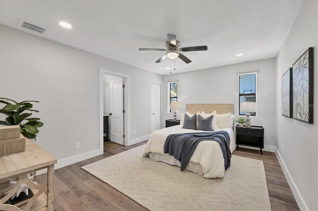 4737 Del Rio Way South Gulfport, FL 33711 - Photo 17 of 55 a bedroom with a bed and a potted plant on the dresser