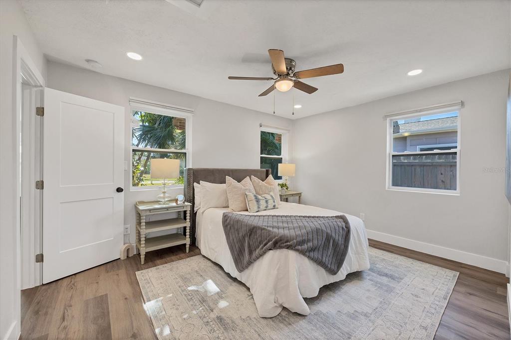 4737 Del Rio Way South Gulfport, FL 33711 - Photo 21 of 55 a spacious bedroom with a bed and a chandelier