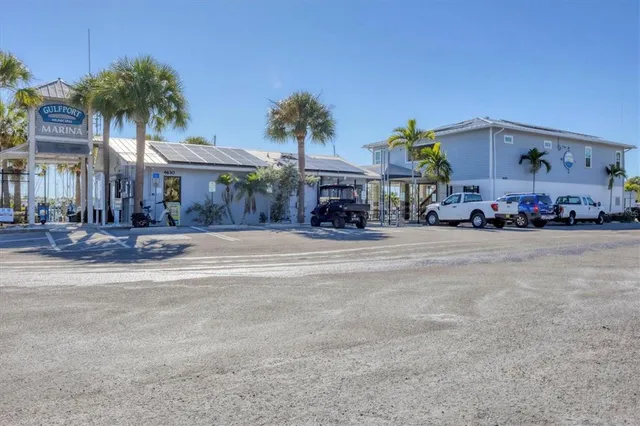 a front view of a building with streets and trees