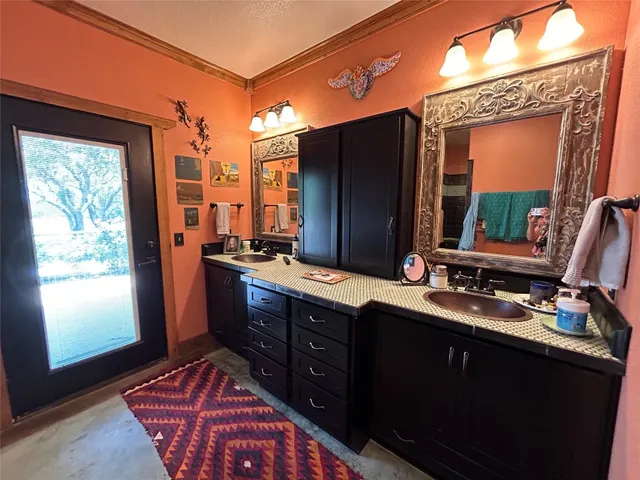 a bathroom with a granite countertop sink toilet and a mirror