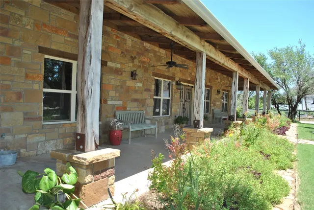 a backyard of a house with outdoor seating