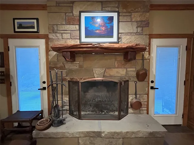 a living room with furniture kitchen view and a large window