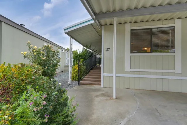 a porch with seating space and garden view