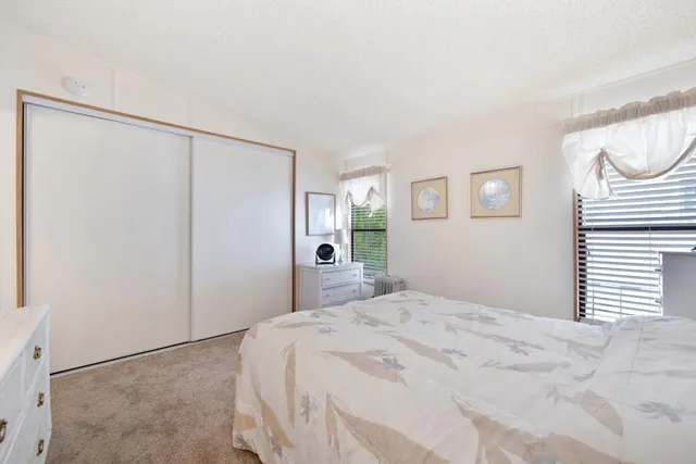 a view of a white house with a yard