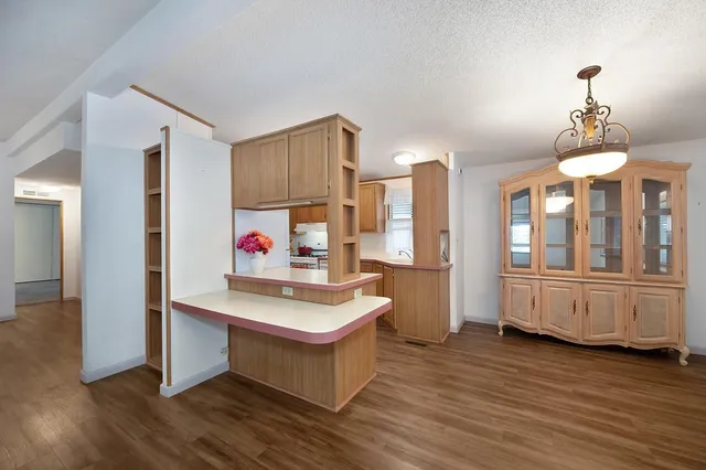 a kitchen with stainless steel appliances granite countertop a sink and a refrigerator