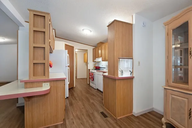 a kitchen view with wooden floor and furniture